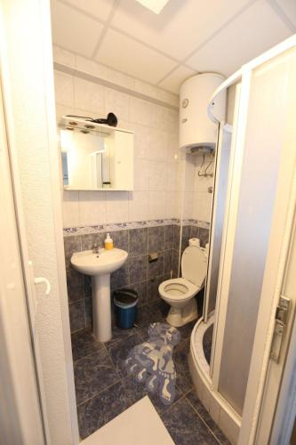 a bathroom with a toilet and a sink at Villa Kaya in Ohrid