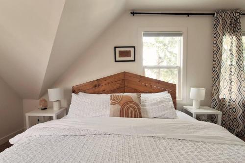 a bedroom with a large white bed with two lamps at Charming Inner City Home in Calgary