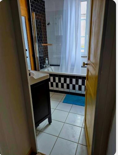 a bathroom with a shower and a sink and a tub at Chambre d'hôtes Abbatiale in Bernay