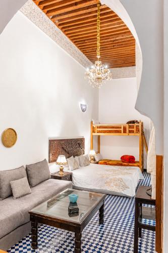 a living room with a couch and a table at Riad Noujoum Medina Fez in Fez