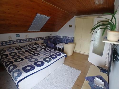 a bedroom with a bed and a wooden ceiling at Czanek Apartman in Komárom