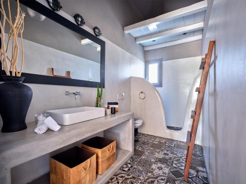 a bathroom with a sink and a mirror at SeaSalt Dream Villa,Santa Maria 5 min from Naousa in Santa Marina