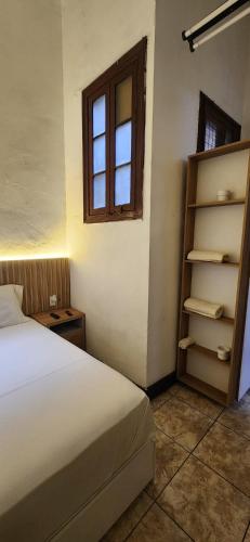 a bedroom with a bed and a shelf and a window at Lima Centro Apartment 3 in Lima