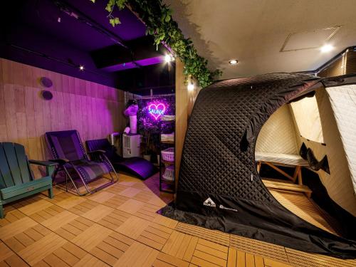 a room with a tent and a table and chairs at Anshin oyado Tokyo Woman Shinjuku Ogikubo in Tokyo