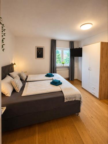 a bedroom with a large bed and a window at Ferienwohnung Wendelstein in Kiefersfelden