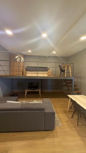 a living room with a bed and a table at Matosinhos Urban Loft in Matosinhos