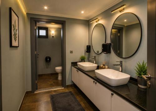 a bathroom with two sinks and a mirror at Eylül Homes in Trabzon