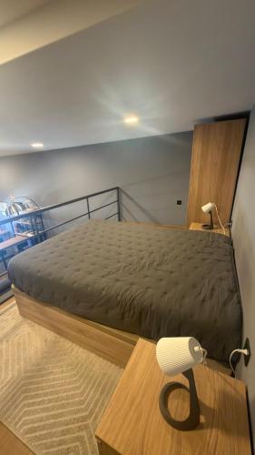 a bedroom with a bed and a white chair at Matosinhos Urban Loft in Matosinhos