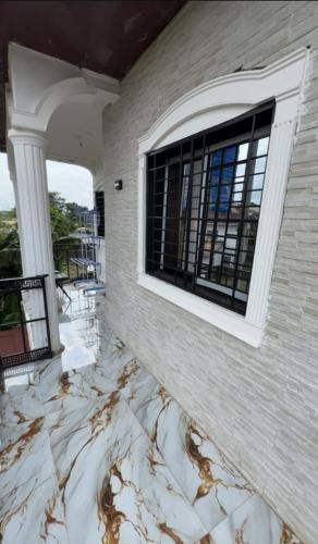 a house with a marble floor and a window at Angevita City1 in Edéa