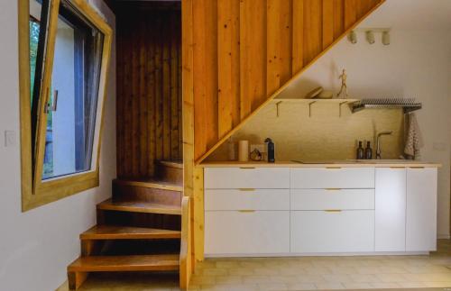a kitchen with a sink and a staircase at La VilLaye in Laye