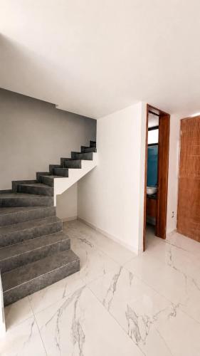 a staircase in a white room with marble floors at Bowra World Cup House, Akron Stadium 5 in Guadalajara