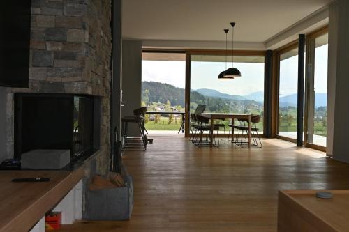 a living room with a fireplace and a table with chairs at Haus Preber in Mariapfarr