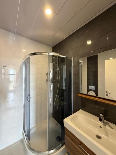 a bathroom with a shower and a sink at My Sweet Apartment in Tbilisi City