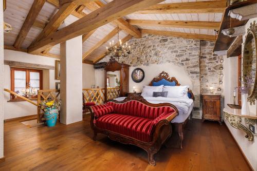a bedroom with a bed and a stone wall at Krasna Hiška - Authentic Heritage Home in Sežana