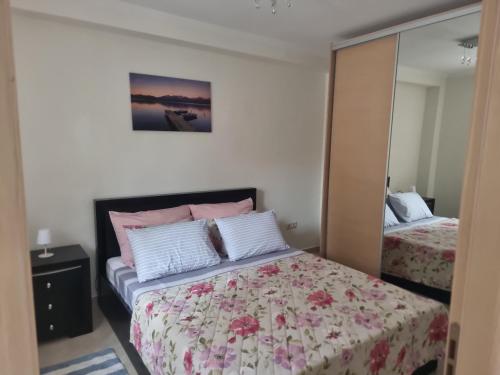 a bedroom with a bed and a mirror at Blue Serenity in Nea Vrasna