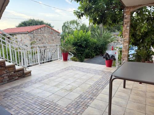 a patio with a table and a fence at "U Monte Rossu" – T2 paisible | by Efficios in Petreto-Bicchisano
