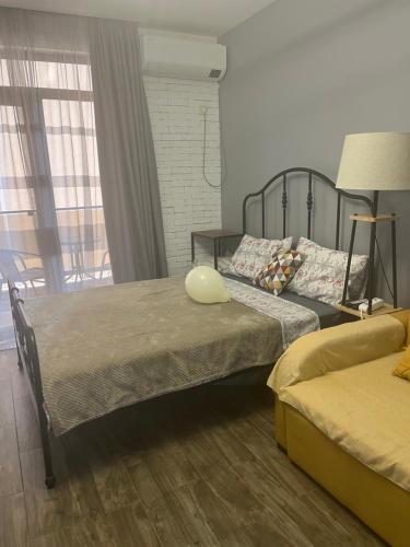 a bedroom with two beds and a large window at A cozy apartment near the sea in Kvariati