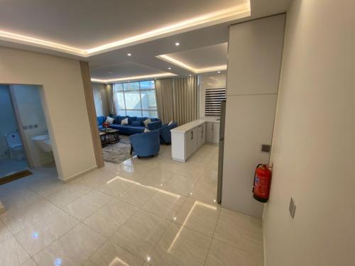 a living room with a blue couch and a living room at فلل دوبلكس - جدة in Jeddah