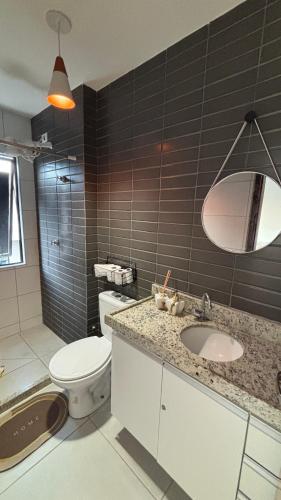 a bathroom with a toilet and a sink at Flat Forte Orange - Ilha de Itamaracá in Itamaracá