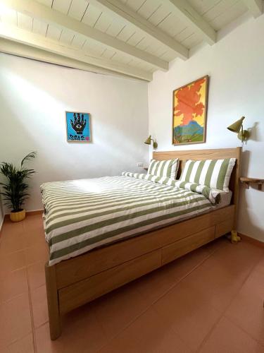 a bedroom with a bed in a white room at Casita Drago in Santa Cruz de la Palma