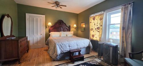 a bedroom with a bed and a ceiling fan at Niagara Historic Inn in Lockport
