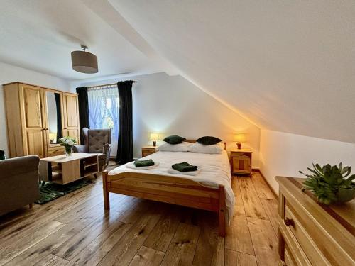 a bedroom with a bed and a desk and a chair at Orlikowe Wzgórze in Rabe