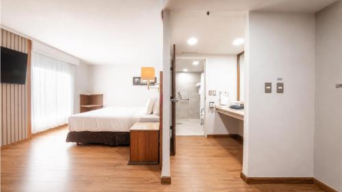 a hotel room with a bed and a bathroom at Holiday Inn Orizaba by IHG in Orizaba