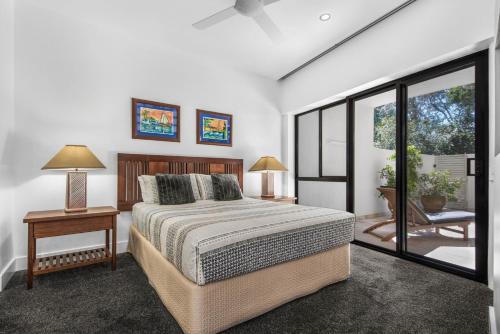 a bedroom with a large bed and a window at Mirra Chana Beachfront Apartments Mooloolaba in Mooloolaba