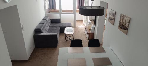 a living room with a couch and a table at Tami Apartman Hviezdoslavova 2, Liptovsky Mikulas, Private Parking in Liptovský Mikuláš