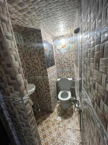a small bathroom with a toilet and a sink at Ryad Cherkaoui in Fez