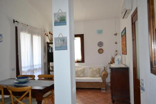a living room with a table and a dining room at Casa Signorile in Villasimius