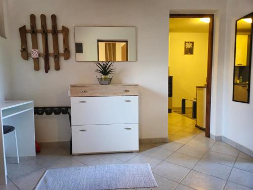 a room with a white dresser and a mirror at Kuća za odmor Skela in Glina