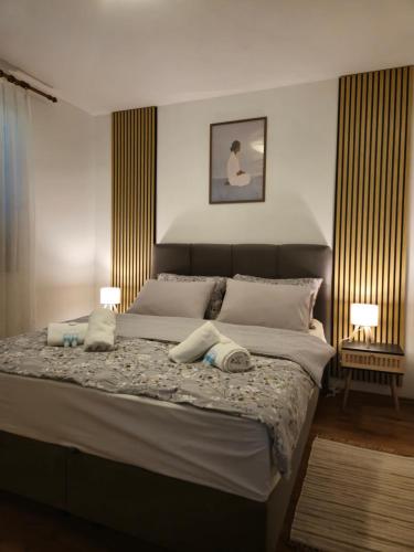 a bedroom with a large bed with two towels on it at Kuća za odmor Skela in Glina