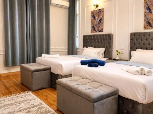 a hotel room with two beds and a couch at Yacoubian Suites in Cairo