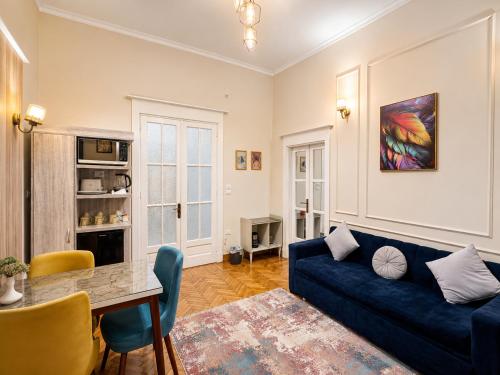 a living room with a blue couch and a table at Yacoubian Suites in Cairo