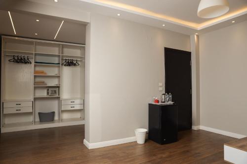 a kitchen with white walls and a black cabinet at Munir`s residence 2 in Cairo