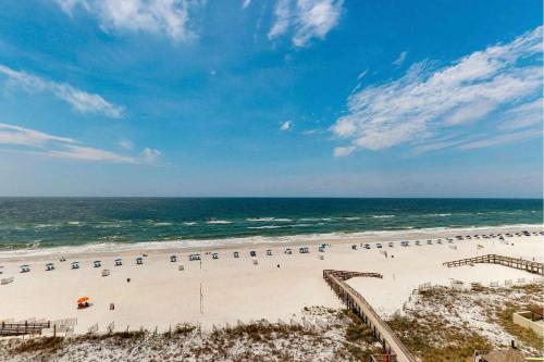 an aerial view of a beach with chairs and the ocean at Beachfront Paradise at Phoenix II 2046 in Orange Beach