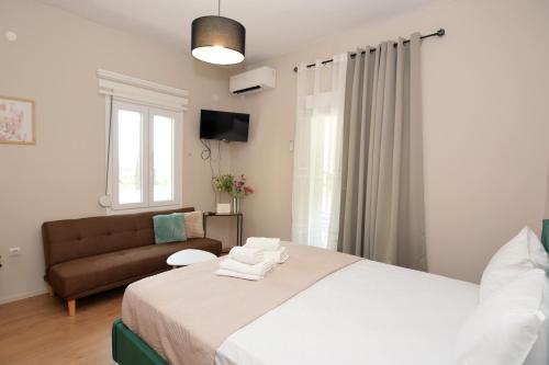 a bedroom with a bed and a couch at Olympian Kavala in Kavála