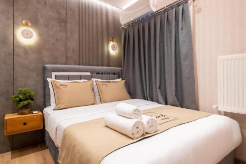 a bedroom with a bed with towels on it at Platine Plus Suite in Istanbul