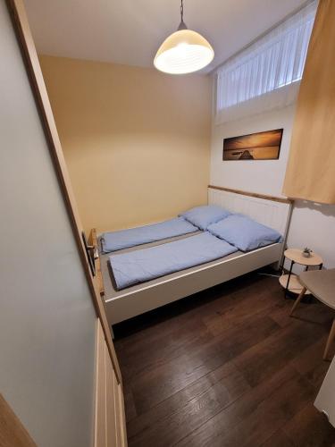 a small bedroom with a bed and a staircase at Magic Downtown Szeged in Szeged