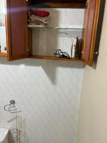 a bathroom with a telephone on a tiled wall at Pink house in Port Antonio