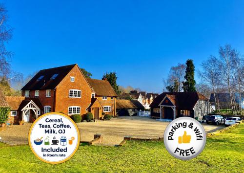 two frisbee signs in front of a house at Hillside Farm Barn in Woking