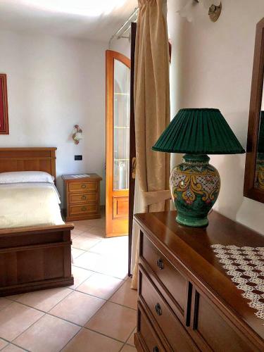 a lamp on top of a dresser in a bedroom at Villa Mattera - Sea - Hot Springs - Private Parking in Barano d'Ischia
