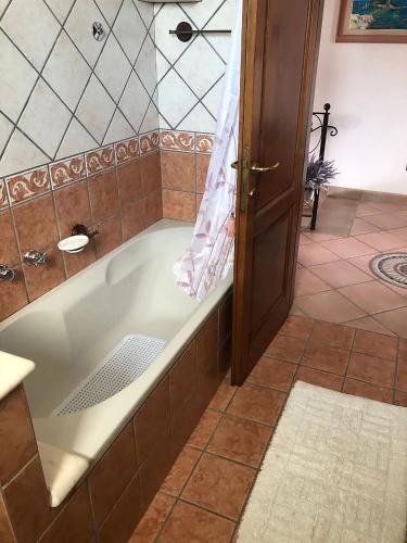 a bath tub in a bathroom with a shower at Villa Mattera - Sea - Hot Springs - Private Parking in Barano d'Ischia