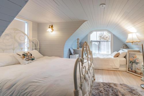 a bedroom with two beds in a attic at The Cottage and Castle in Chemainus