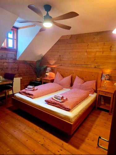 a bedroom with two beds and a ceiling fan at Sonnleit'n Zimmer 3 in Abtenau