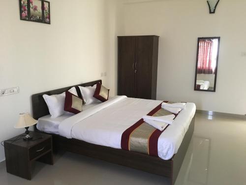 a bedroom with a large bed in a room at Sun Shine in Chennai