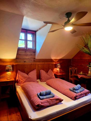 a bedroom with two beds with pillows on them at Sonnleit'n Zimmer 2 in Abtenau