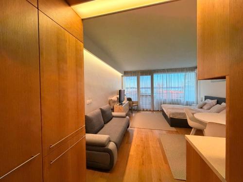 a living room with a couch and a tv in it at Balino 57 in Balatonlelle