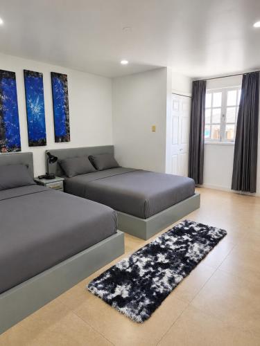 a bedroom with two beds and a rug at Inn At Juzani Boutique Hotel in Lambeau